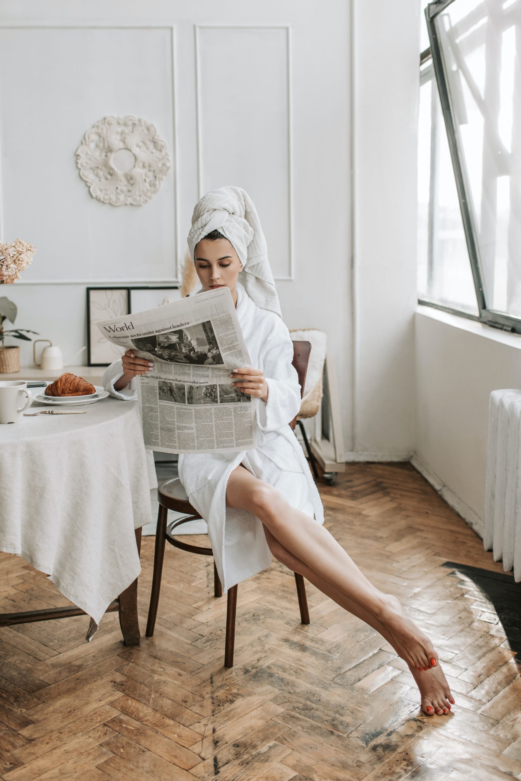 single woman reading investment section of newspaper