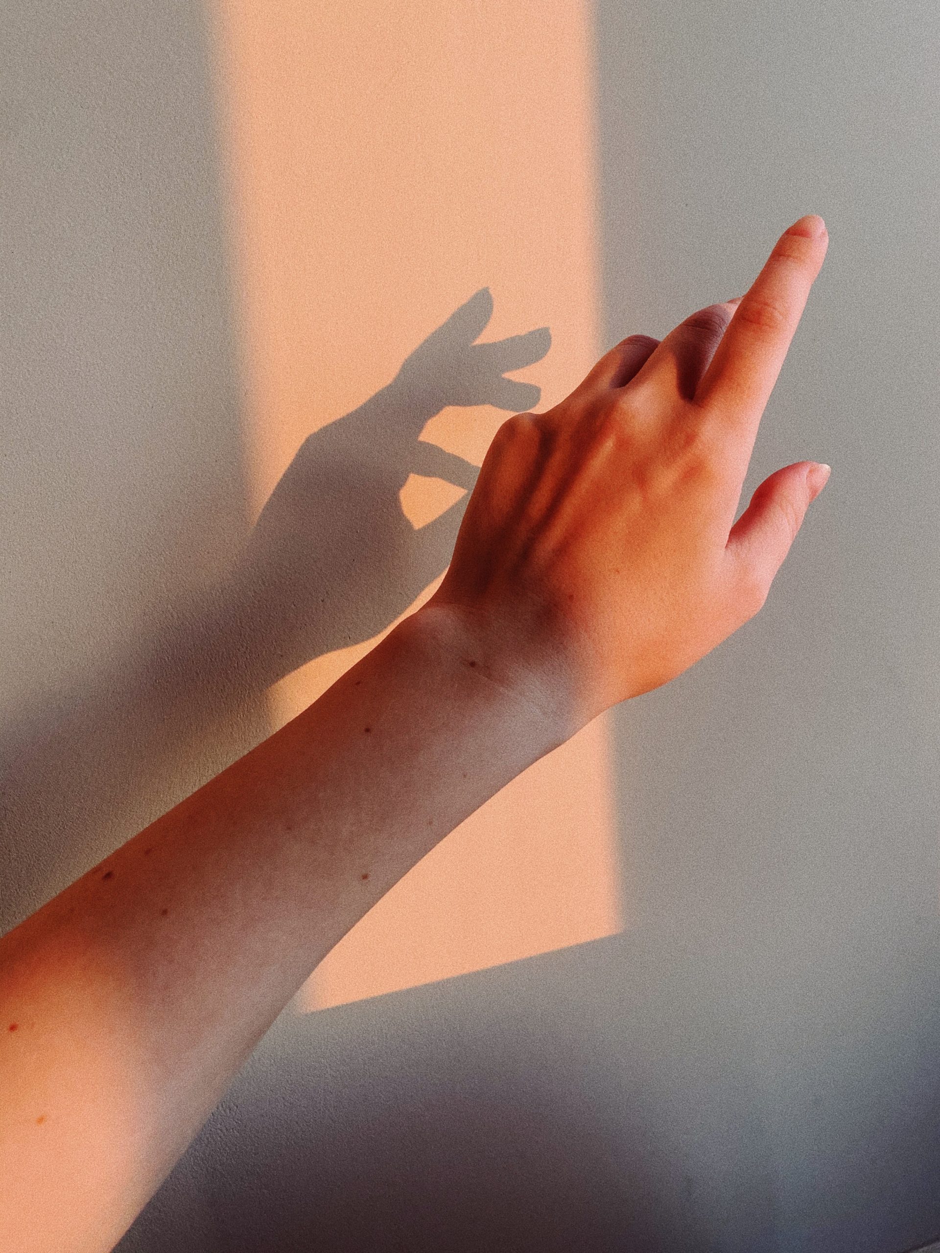 shadow of woman's hand pointing